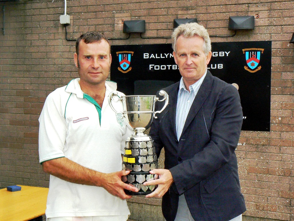 Graham Moreland receives the the trophy from Philip Black